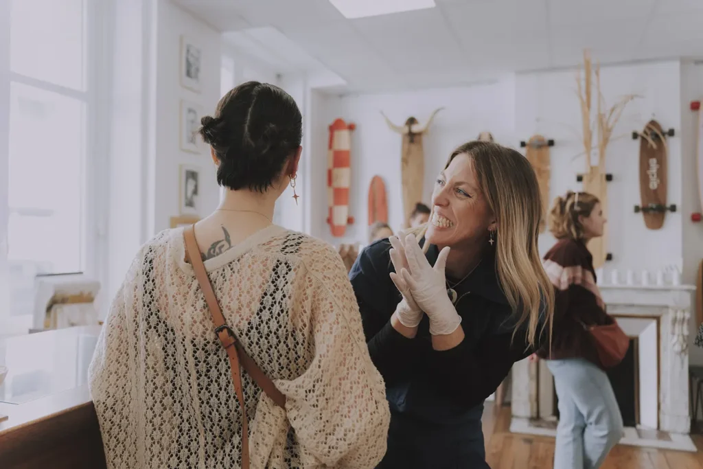 Ambiance : Sourires et convivialité entre l'équipe et les clients lors de l'événement au shop Vauban Piercing & Tattoo à Bayonne, image par l'agence ADIO.
