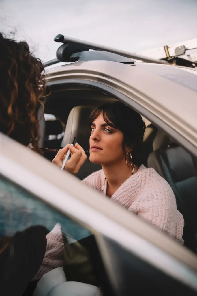 Photos des backstage : Victoria Picone en pleine séance de maquillage dans une voiture de tournage par l'agence ADIO.