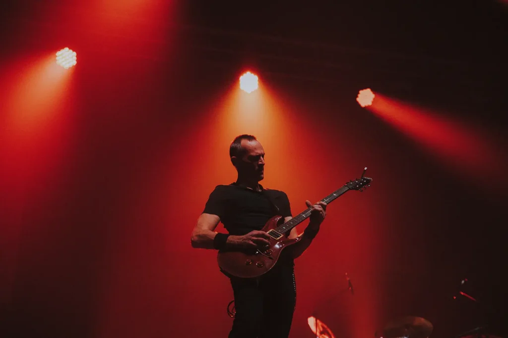 Teaser vidéo : guitariste sous un éclairage rouge intense à l'Arkéa Arena réalisé par ADIO