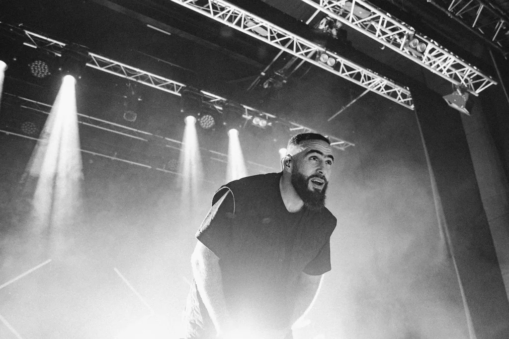 Photographie de concert : Portrait noir et blanc expressif de Médine sur scène à l'Atabal Biarritz capturé par l'agence ADIO