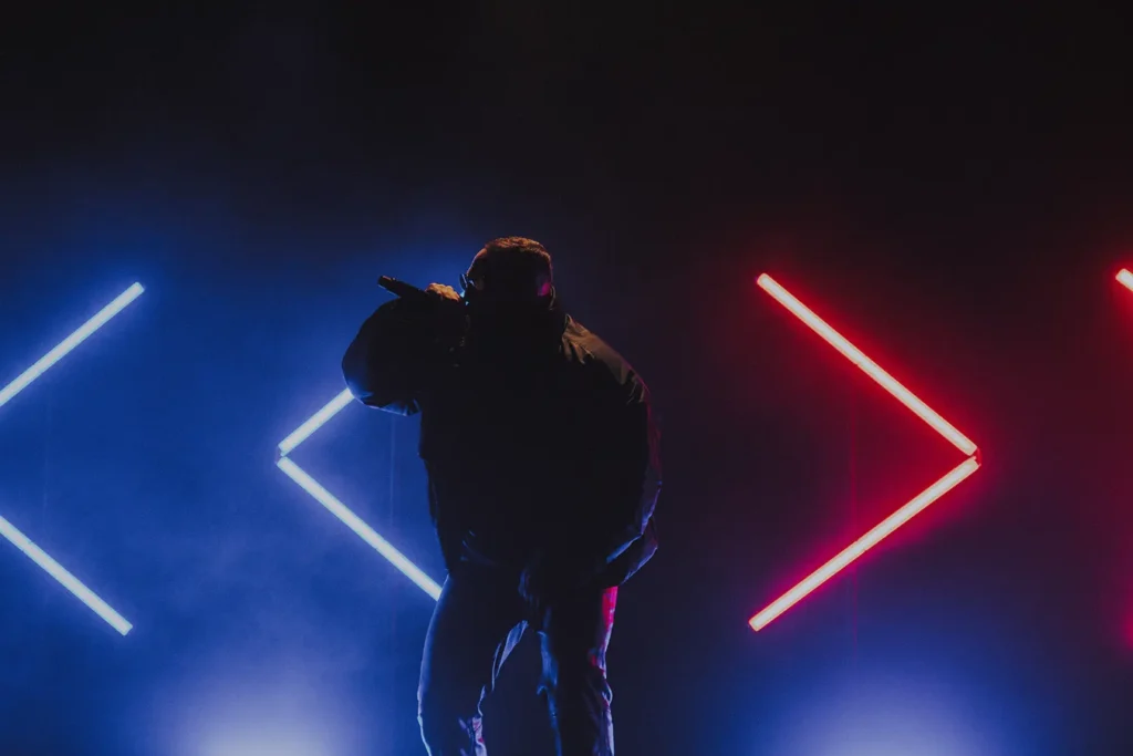 Reportage photo concert : Jeu de lumières bleu et rouge contrasté sur la silhouette de Médine à l'Atabal par l'agence ADIO